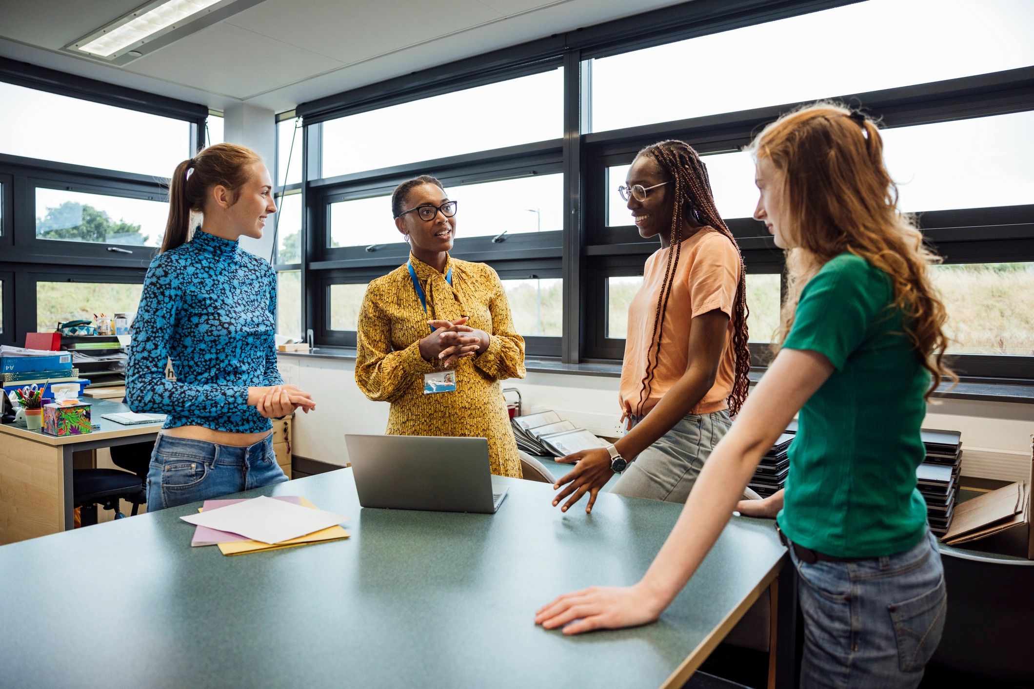 Teacher guiding students during a classroom coaching session