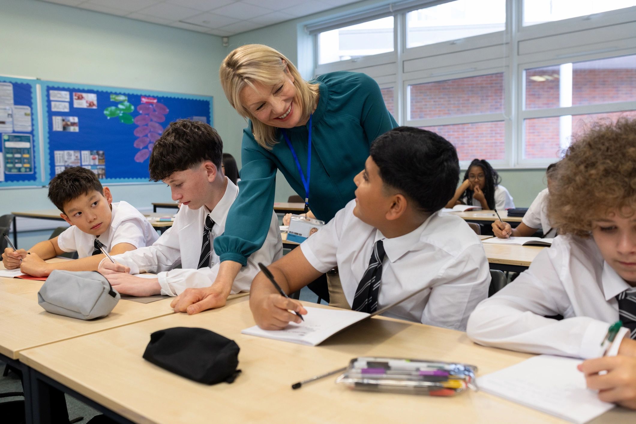 Teacher guiding students in a classroom